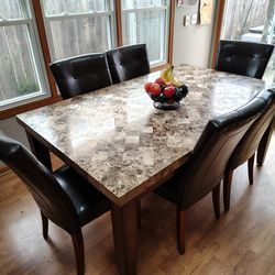 Marble top dining table with 6 leather chairs