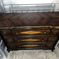 I sell classic-style chest of drawers with diamond-shaped marquetry details and circular decorative hardware.