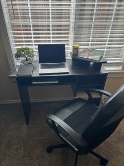 dark wood color desk and black office chair