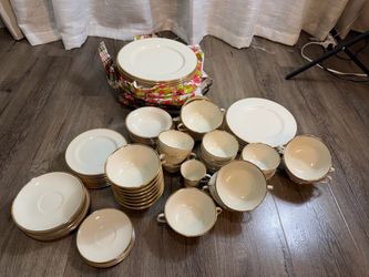 elegant ivory-colored Chinese porcelain dinner set with wide gold rims