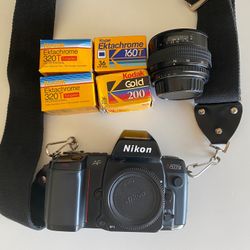Nikon 35mm Film Camera W Lens And 4 Packs Of Film TESTED & WORKING
