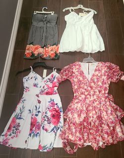 Four women's dresses. Two are new with the tags. All in perfect condition. Size Medium and large. All fit like a medium.