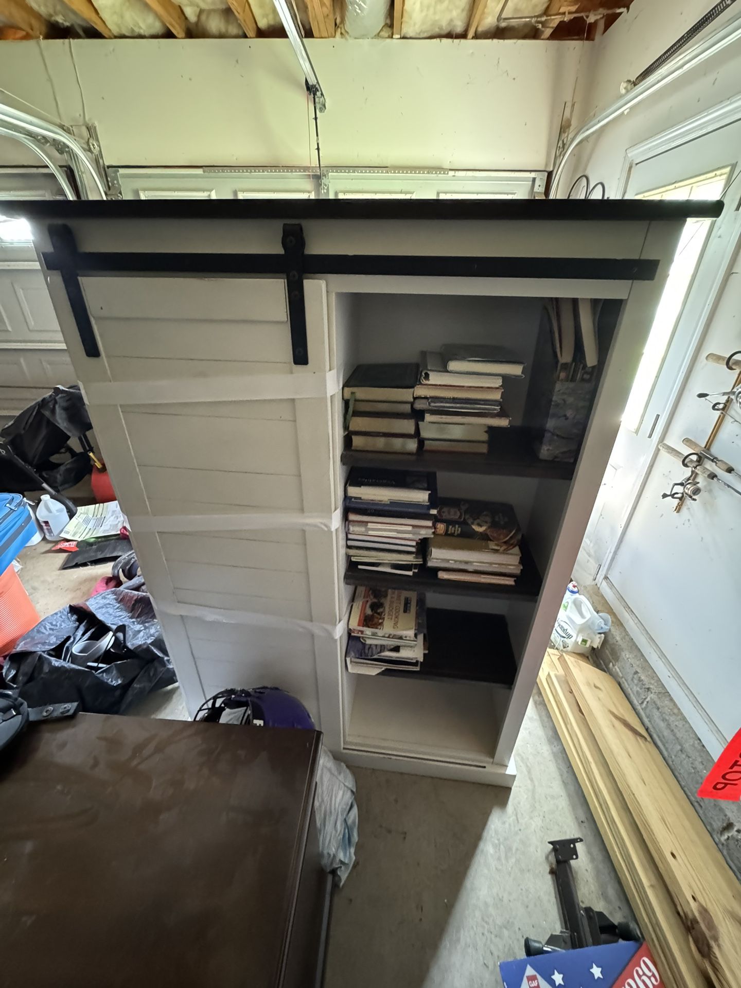 White book shelf with barn sliding door.