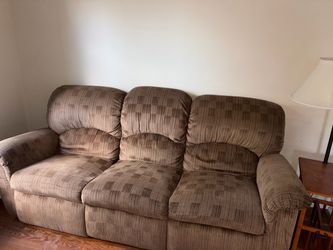 Like New - Brown Fabric Reclining Sofa with overstuffed back cushions, a geometric checkered pattern on the center panels, and vertical texturing.