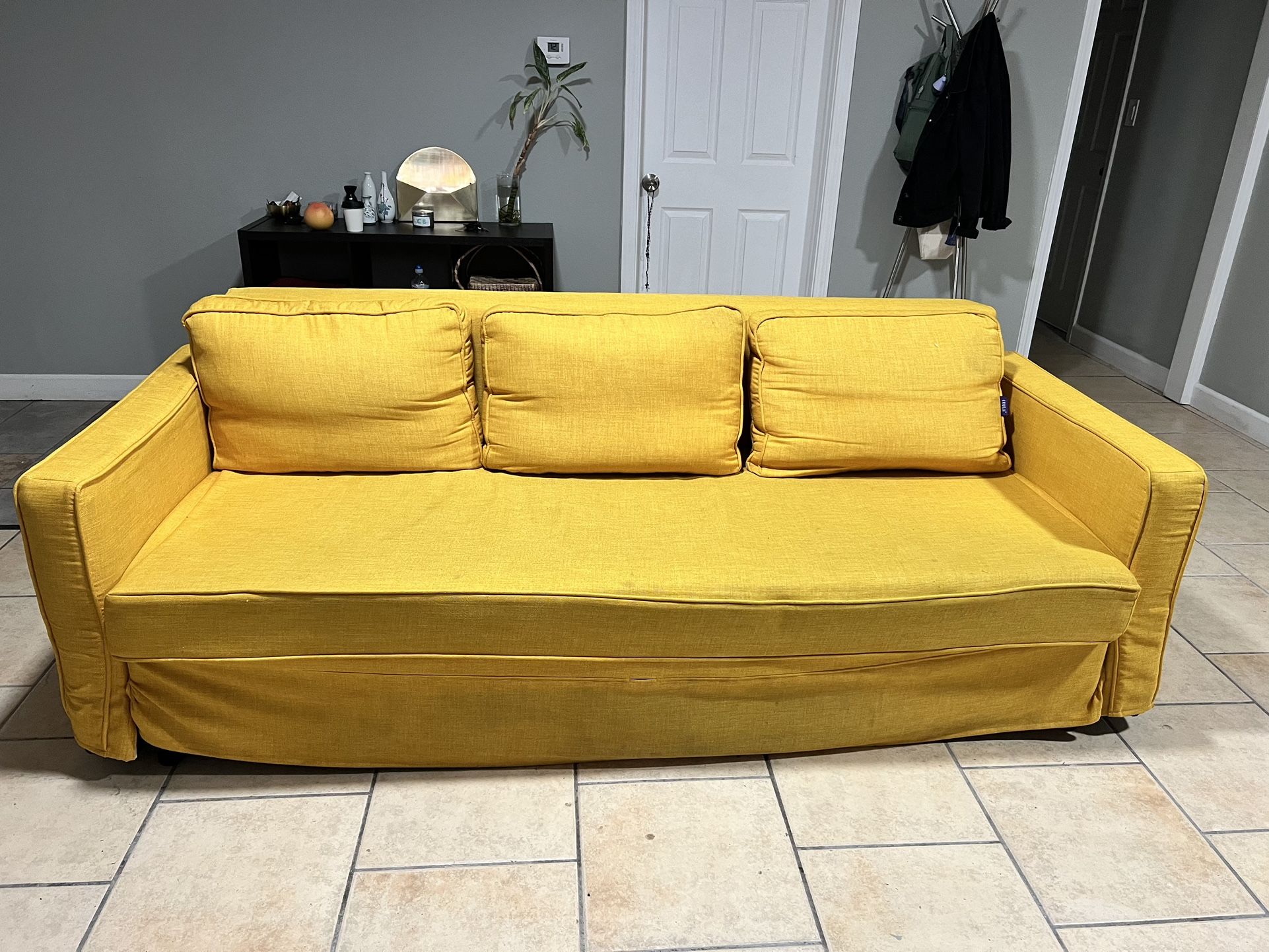 Black Friheten Ikea Couch With Yellow Cover 