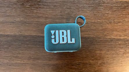 JBL Bluetooth speaker teal waterproof, easy connection.