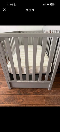 Grey crib with storage