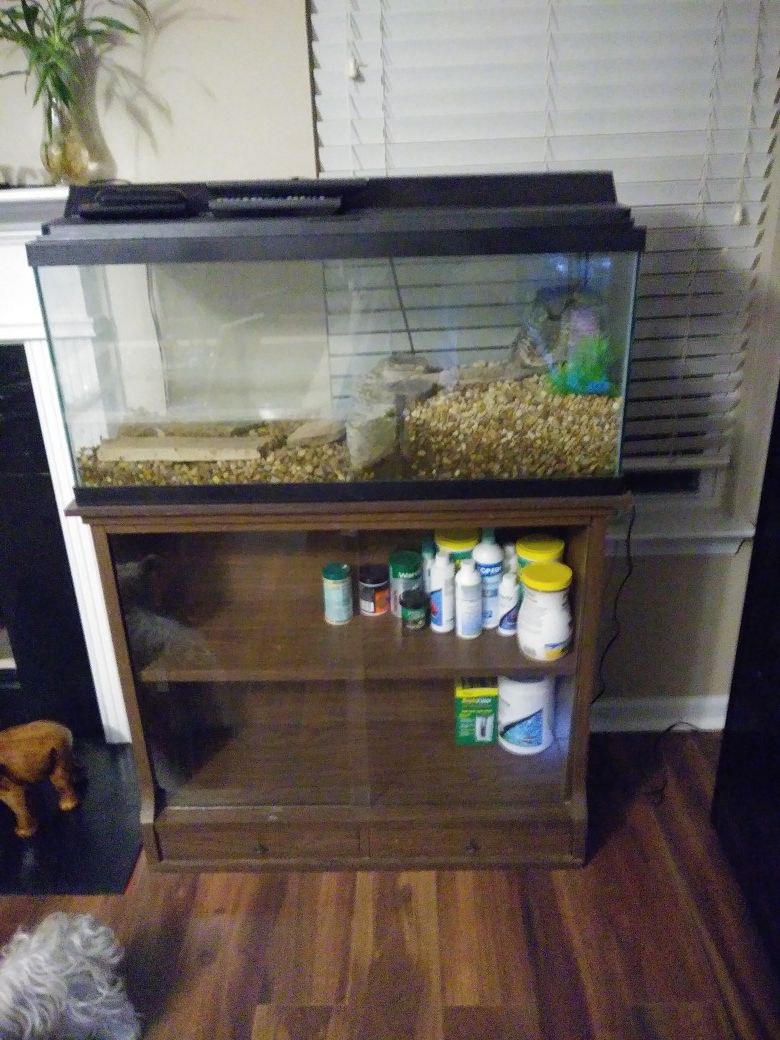 30 gallon fish tank with lighted lid and bookcase.