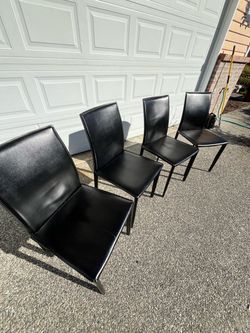 Four black leather chairs