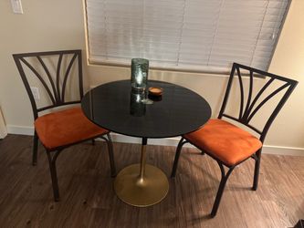 Glass table with two chairs