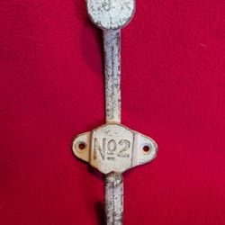 vintage-style cast iron wall hook featuring a white or aged-metal finish and the marking "No 2"