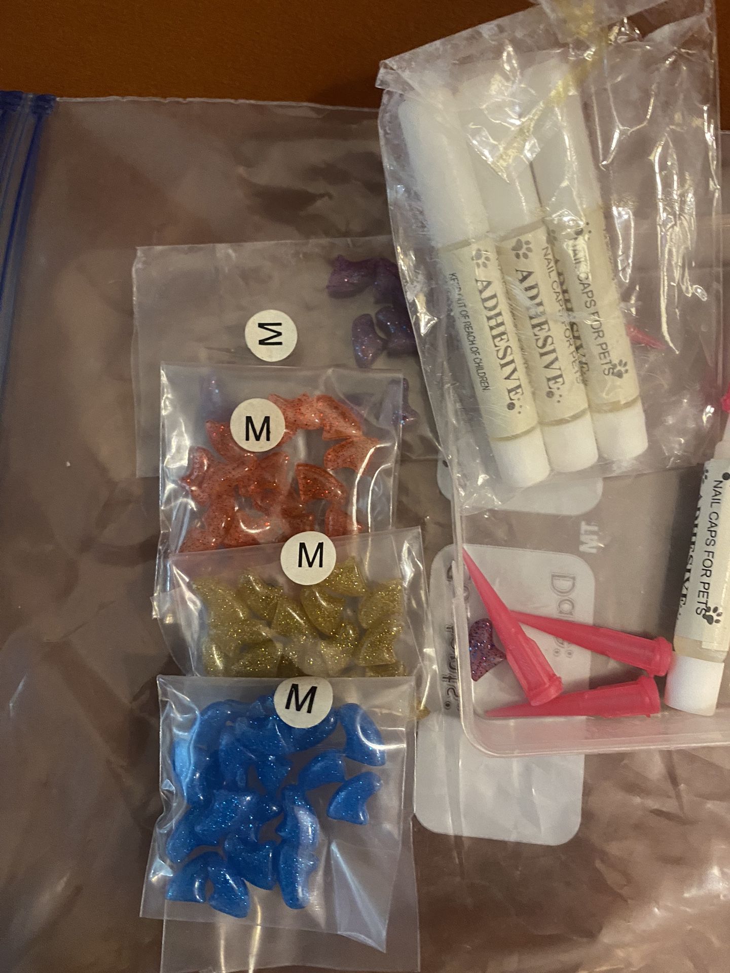 A Set Of Cat Claw Covers With Several Glue Different Colors