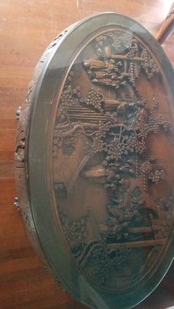 A Chinese hand carved wood coffee table w/glass.