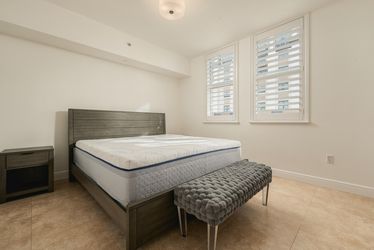 Two nightstands, bed frame, mattress, and bench.