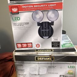2 Defiant  motion light  one black one  white both LED one is solar  powered 