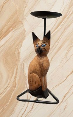HAND-CARVED WOODEN  SIAMESE CAT W/BLUE PAINTED EYES CANDLE HOLDER. BLACK METAL BASE