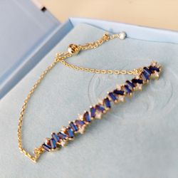 18K Gold Plated Adjustable Tennis Bracelet with Blue Stones and Cubic Zirconia Accents. New. Opened only for photographing. Makes a great holiday Chri