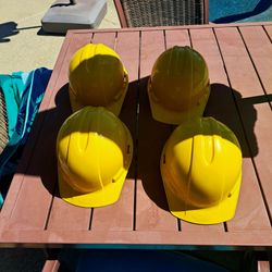 Four Hardhats with four safety vests