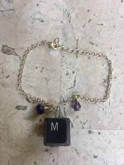 Silver Colored Bracelet With Two Purple / Violet Crystal Beads And Computer Key With M