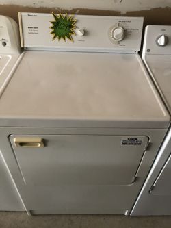 A white front load Magic Chef dryer