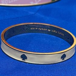 Kate Spade Gold Bangle with a Iight Cream Color Enamel