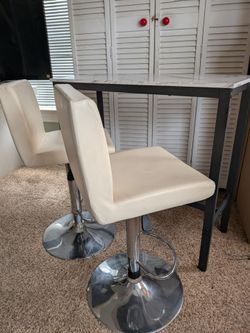 Bar table with swivel high chairs