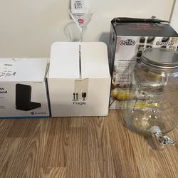 $25 PACKAGE DEAL 💰💰. NEW STANDING PHONE CHARGER.  6 NEW MARTINI GLASSES.  LARGE GLASS DISPENSER WITH SPOUT.  RETAIL $79.!!!   NOW $25 FOR EVERYTHING