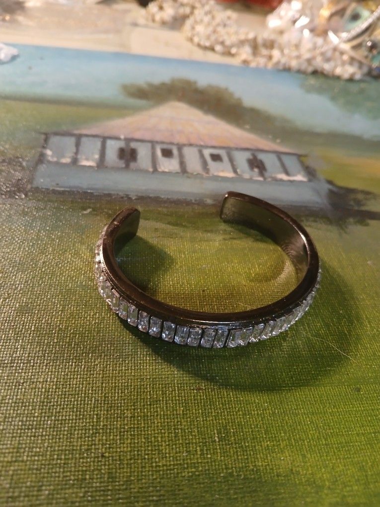 Mark. (or Lia Sophia) gunmetal-tone cuff bracelet enhanced with clear baguette-cut crystals.