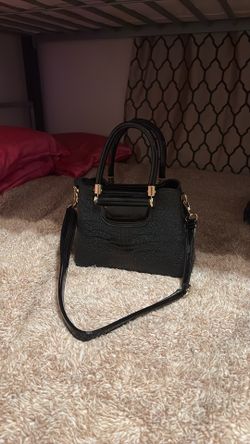 Elegant and structured black crocodile-embossed handbag featuring a dual-texture design with a glossy, patent faux-leather panel accents and polished 