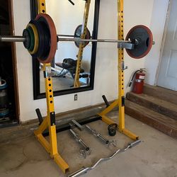 Powertec squat rack with weights and bars.