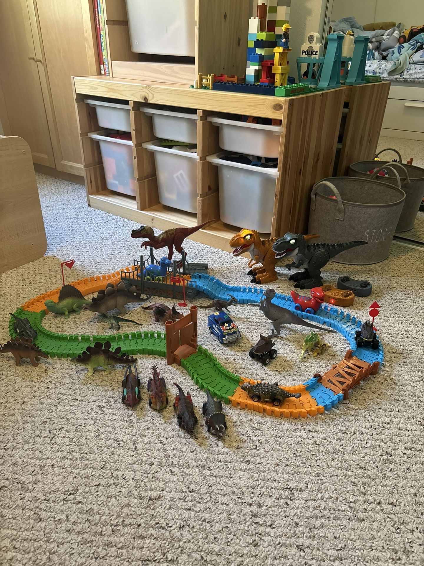 Dinosaur lot that includes remote controlled dinosaurs, track, plastic dinosaurs and Dino cars