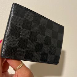 Based on the Damier Graphite canvas, this item appears to be a Louis Vuitton wallet, such as the Amerigo Wallet or the Slender Wallet.
