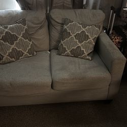 Brown love sofa with two pillows