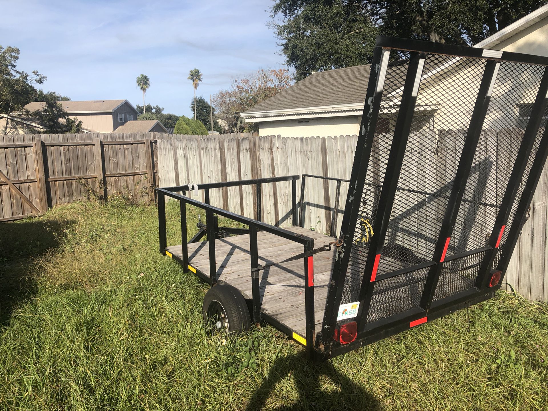 Price reduced Trailer with lights and removable rails extra large steel gate easy access to drive up with mower or equipment
