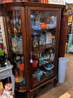 Antique bowed glass cabinet