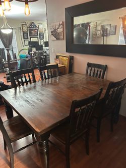 Wood table with divided middle area to make it smaller and wall mirror..