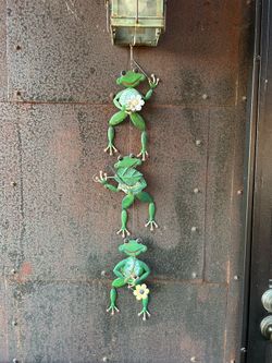 Cute outdoor hanging frog decor.