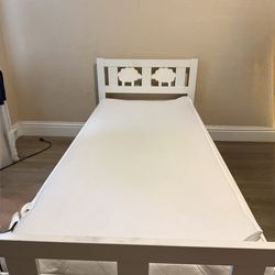 A white IKEA  medium twin bed.