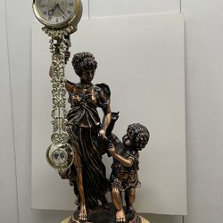 swinging statue clock with musician