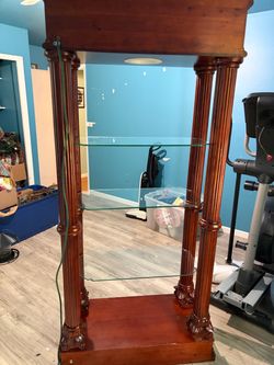 Very beautiful glass shelf with wooden frame .