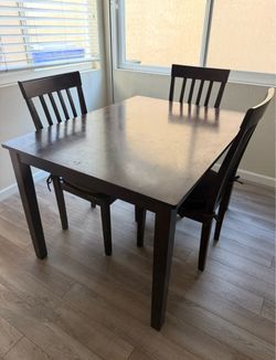 Brown wood table and 3 chairs