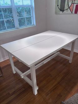 White wooden dining table with extendable ends