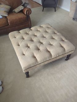 Tan Potterybarn upholstered ottoman with nailhead trim