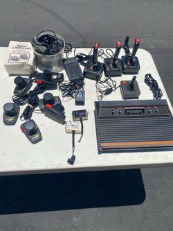 Atari 2600 all cables multiple paddles and joy sticks with all games included