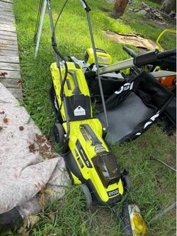 This is a Ryobi 13 in. 11 Amp Corded Electric Walk Behind Push Lawn Mower (Model # RYAC130-S).It features a lime green motor cover and a 13-inch cutti
