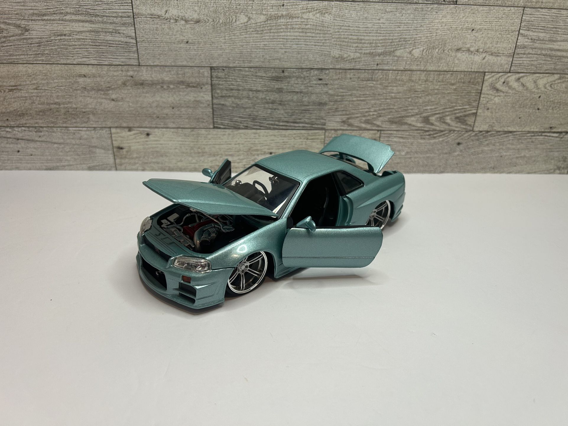 Vintage Jada Toys Fast & Furious Light Blue “2002” Nissan Skyline R34 • Die Cast Metal Body With Moving Parts • Made in China Scale 1:24