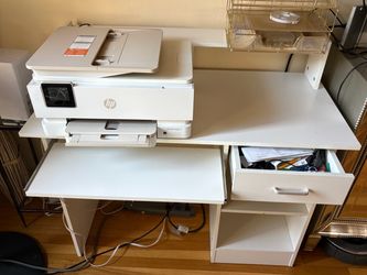 Desk, printer all in one, clipboard, and box of white envelopes
