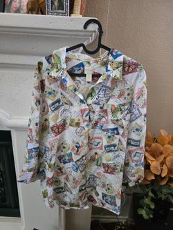 Chico's button-up shirt with vibrant postage stamp and butterfly motifs. White base with an all-over colorful print. Lightweight look and classic coll