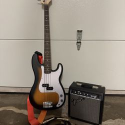 Bass guitar Fender with cord and amplifier 