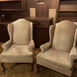 two gold high back classic statement chairs 